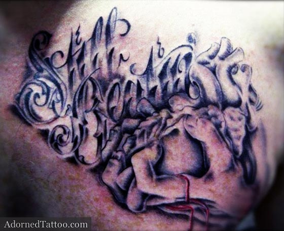 black and grey beating heart chest tattoo