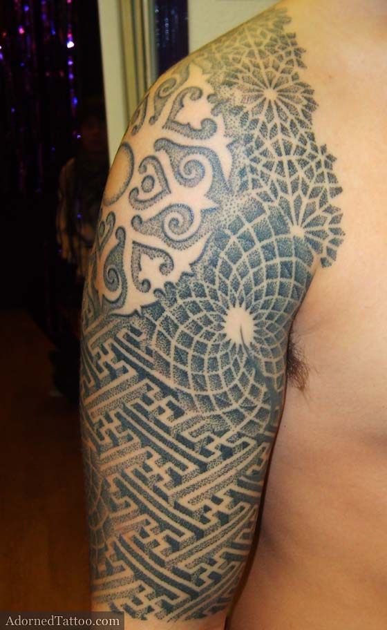 The centrepiece of Lee's dotwork half sleeve tattoo features negative Borneo