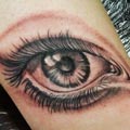 Black and grey eye on ankle tattoo