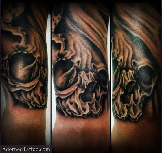 black and grey skull on wrist tattoo