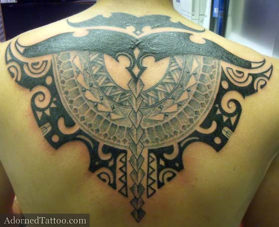 We decided on a Tahitian-style tribal back tattoo with a mixture of solid 